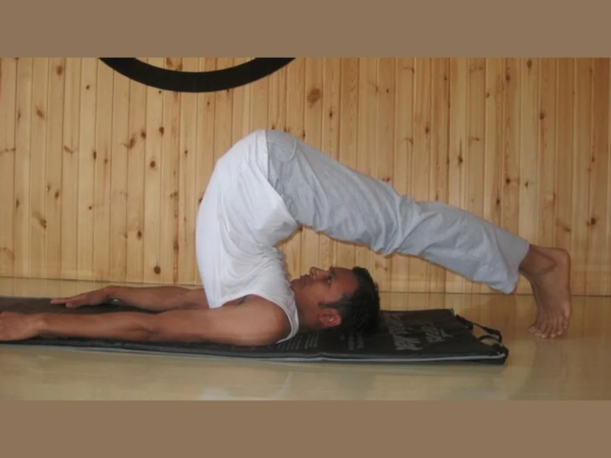 Plow Pose (Halasana) — photograph